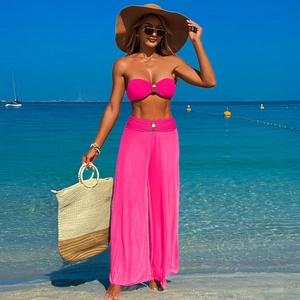 Detail of rose pink tube top and high waist wide leg pants set with golden buckle