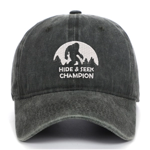 Close-up of Bigfoot embroidery and Hide & Seek Champion text on gray washed baseball cap