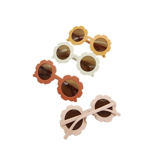 Matte flower-shaped kids sunglasses in cream, mustard, rust, and pink colors