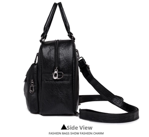 Side view of black embossed faux leather backpack showing dual zipper compartments