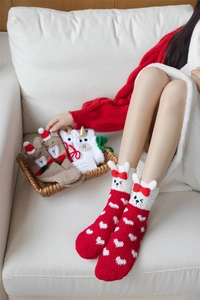 Detail of coral fleece Christmas socks featuring plush 3D bunny ears and heart patterns