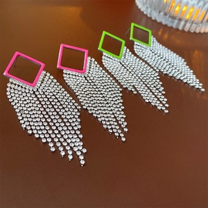 Detailed shot of hollow diamond tassel earrings in rose pink and neon green finishes
