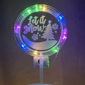LED Christmas cake topper with Let It Snow engraving and glowing multi-color acrylic panel