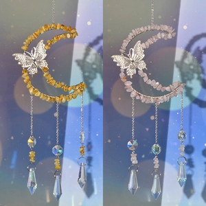 Detail of pink and yellow crystal suncatchers with moon and butterfly wire wrap