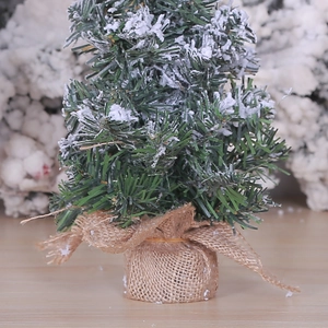 Miniature artificial Christmas tree with snow effect and burlap base for desk decor