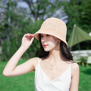 Detail of breathable crochet bucket hat in light beige with natural sun protection weave