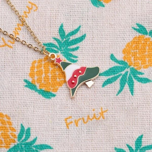 Golden necklace with a green enamel Christmas tree pendant and festive red star details