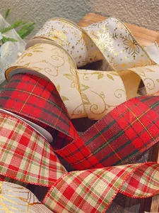 Macro shot of glittery gold snowflakes and plaid patterns on burlap Christmas ribbon rolls
