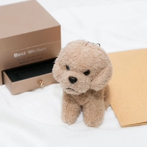 Macro detail of a beige plush teddy dog keychain with soft fur texture and metal ring