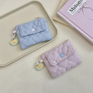 Detail of quilted heart striped coin purses in pink and blue with cute bear charms