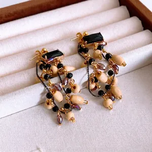 Vintage gold earrings with black square glass stones and wooden bead tassel dangles