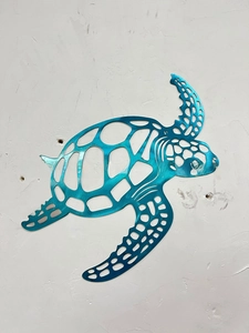 Detail of blue gradient sea turtle metal wall art showing laser-cut hollow pattern
