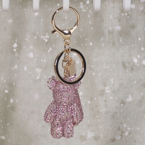 Detail of pink crystal studded bear keychain with gold plating and lobster clasp