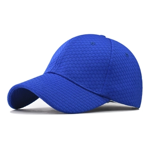 Detail of bright blue baseball cap featuring a fine diamond grid texture and stitching