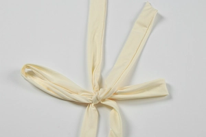 Detailed view of criss-cross halter straps on a cream backless mermaid dress