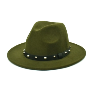 Detail of olive green fedora hat featuring black leather band and silver studs
