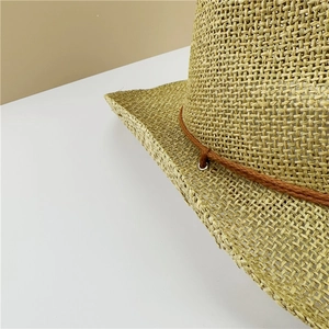 Detailed close-up of breathable woven straw cowboy hat with decorative brown braided rope