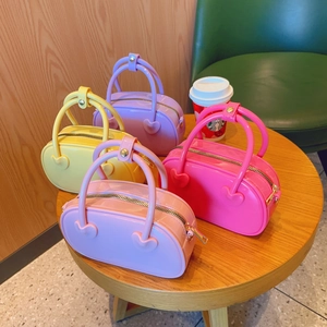 Mini jelly crossbody handbags in candy colors on a wooden table with a soft aesthetic
