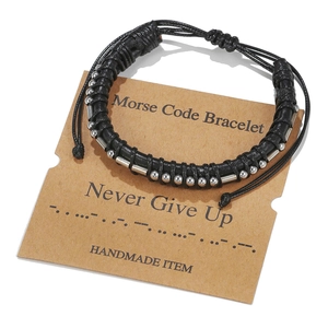 Detail of Morse code bracelet with silver beads on a Never Give Up kraft card