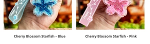 Detail showing blue and pink cherry blossom starfish keychains with glitter and Happy wrist strap