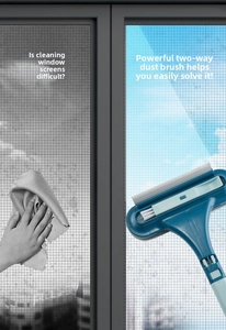 Detail view of a double-sided window screen cleaning brush with squeegee for household use.