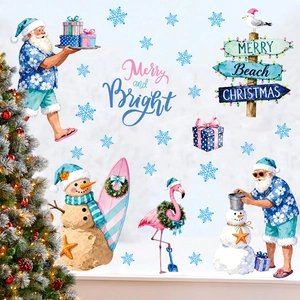 Tropical beach Christmas window stickers featuring Santa, flamingo and sand snowman