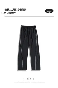 Detail of elastic drawstring waist and side stripes on black ice silk trousers