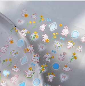 Detailed view of 5D embossed nail stickers featuring cute red rabbits and yellow flowers