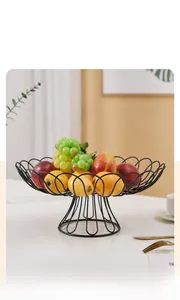 Detail of black iron fruit basket with petal edges and base in a home setting