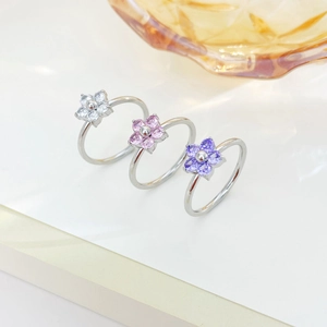 Three minimalist flower rings with silver bands and white pink purple zircon petals