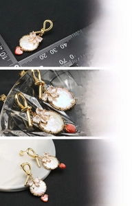 Detailed close-up of baroque pearl earrings with 18k gold plating and heart charms