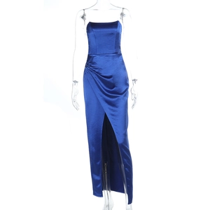 Detail of high-slit hem and smooth satin fabric texture on deep blue strapless evening gown