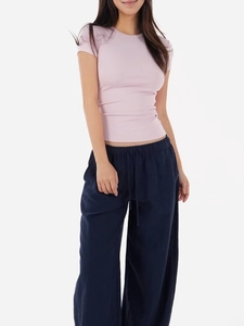 Slim fit pink t-shirt paired with navy blue wide leg drawstring trousers for women