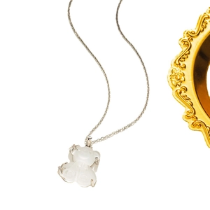 Titanium steel necklace with white jade flower pendant and sparkling stone border