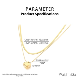 Detail view of double-layered stainless steel necklace with gold heart pendant