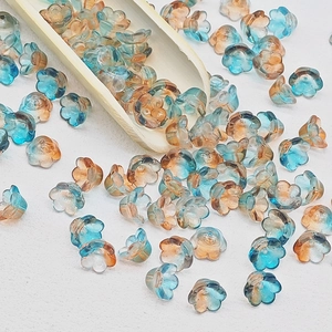 Macro shot of lily of the valley glass flower beads with blue and amber gradient