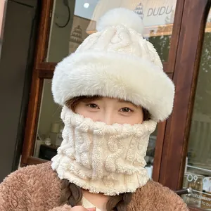 Close-up of beige cable knit hat and thick fleece scarf set with fluffy faux fur trim