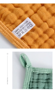 Close-up of quilted muslin cotton burp cloth texture with convenient hanging loop