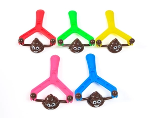 Close-up of five colorful plastic slingshots with funny cartoon poop emoji toys