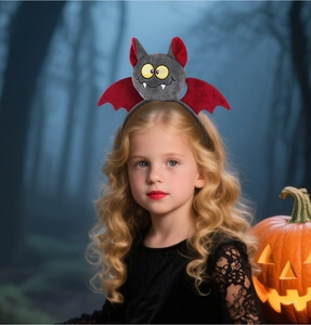 Halloween bat headband with plush wings and red ears shown on a child in a spooky forest