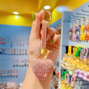 Pink rhinestone heart keychain with gold ring clasp and tassel detail close-up