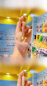 Pink rhinestone heart keychain with gold ring clasp and tassel detail close-up