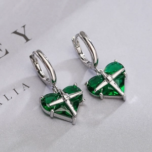 Minimalist gold-plated heart earrings featuring green crystals and silver star motifs
