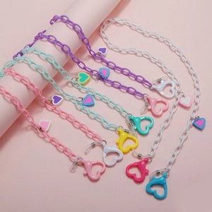 Detail of colorful macaron beaded eyeglass chains with heart clips and heart charms
