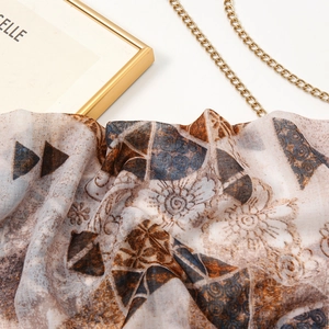 Detailed close-up of ink butterfly print scarf fabric texture with artistic patterns