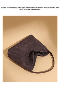Detailed view of the dark brown hand-woven leather texture on a luxury tote bag