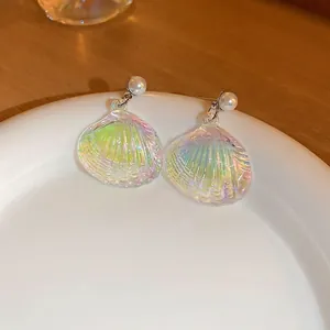 Iridescent shell-shaped drop earrings with white pearls and silver needles for women
