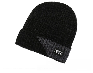 Detail showing the ribbed knit texture and GD woven label on a winter beanie hat