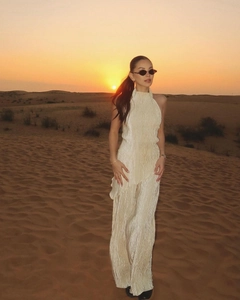 Detail of pleated fabric texture on a cream halter top and wide leg pants set