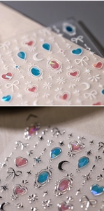 Close-up of holographic butterfly nail stickers with 3D relief hearts and stars